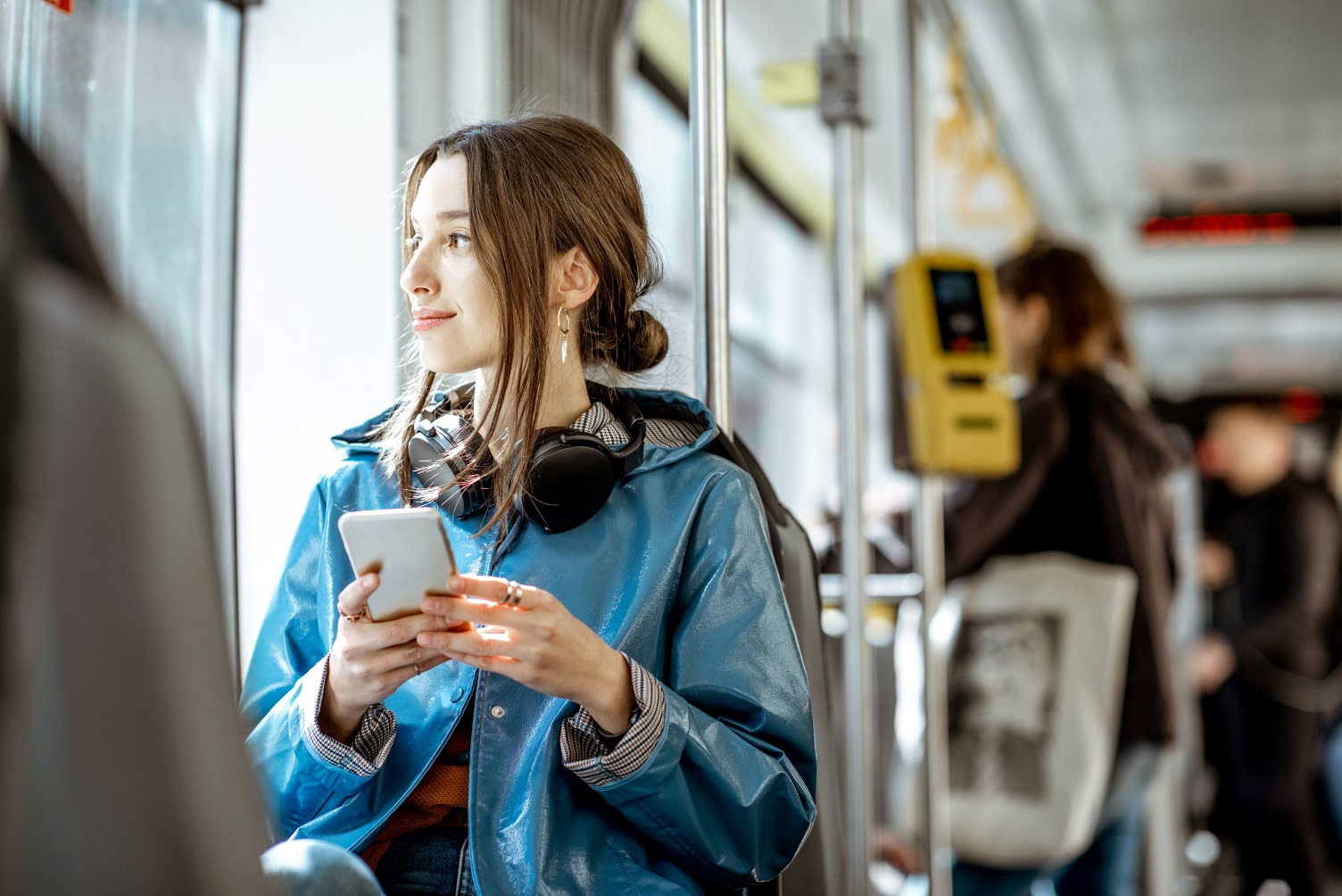 A woman on public transport using the MyLearning app.